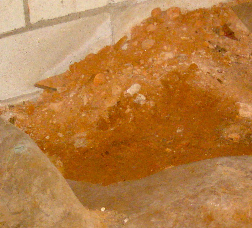 Crawl space dirt that's wet where it was covered by plastic and dry where it was uncovered