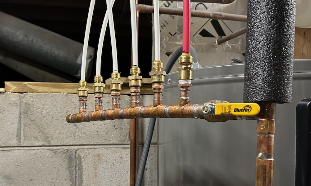 A Hot Water Manifold With 1/4 Inch And 3/8 Inch PEX Tubing