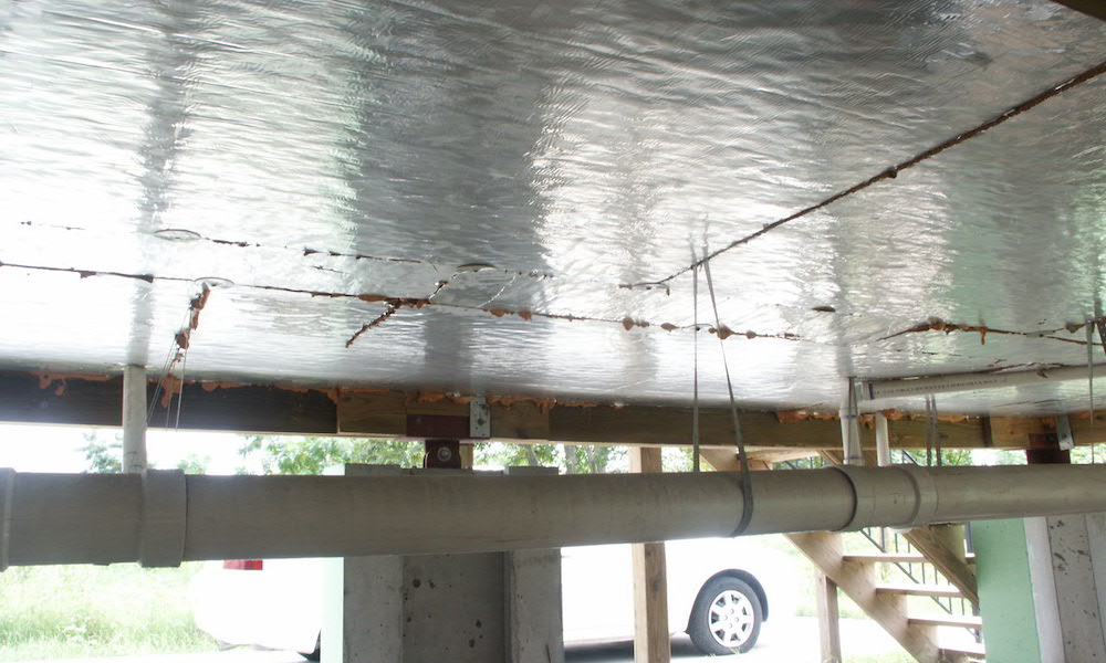 An open crawl space with the floor above insulated and sealed below the joists